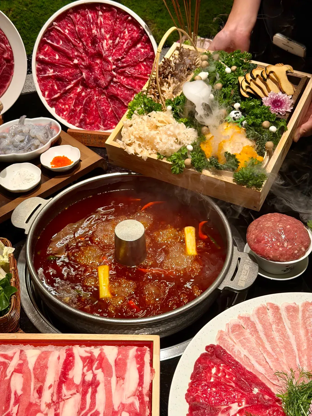 Sichuan hotpot bubbling with chili oil, sliced meats, and vegetables — the quintessential Chengdu dining experience